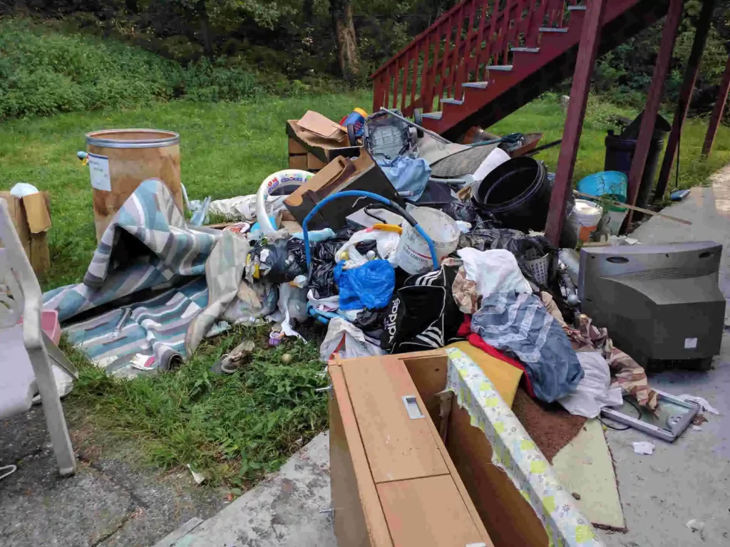 Before and after comparison of residential junk removal by Ryan’s Junk Truck in Rehoboth, MA, showing a cleared and organized space after furniture and debris removal.